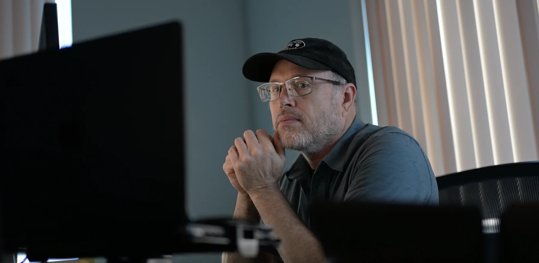 Illya Friedman seated thoughtfully in a warm workshop setting